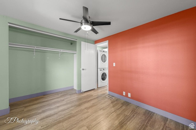 1160 E Telegraph Unit 227, Washington, UT 84780 - washroom featuring estacked washer and dryer, ceiling fan, and wood finished floors