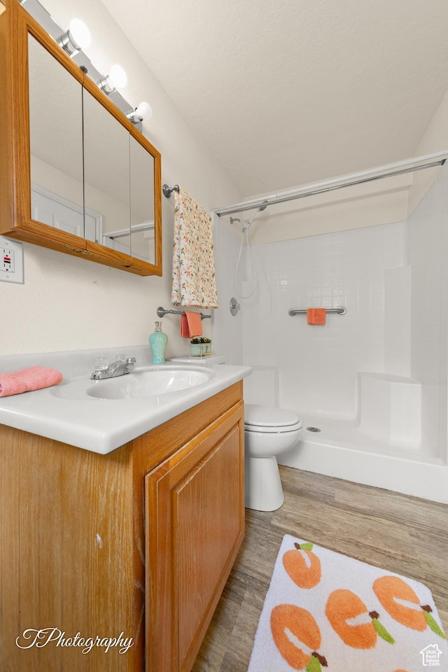 1160 E Telegraph Unit 227, Washington, UT 84780 - full bathroom featuring a shower, vanity, and wood finished floors
