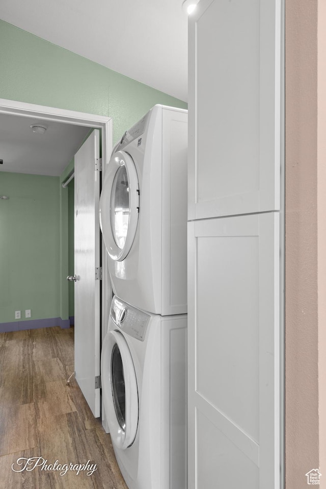 1160 E Telegraph Unit 227, Washington, UT 84780 - washroom with stacked washer / drying machine and wood finished floors