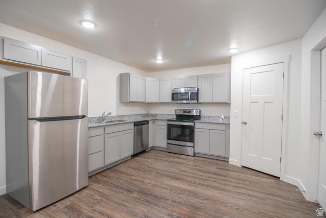 361 W 625 N A-D, Unit A-D Payson, UT 84651 - kitchen with stainless steel appliances, gray cabinetry, dark wood-style floors, and light stone countertops