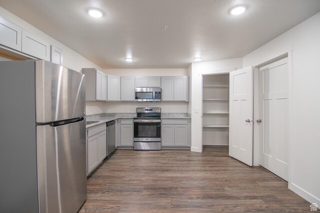 361 W 625 N A-D, Unit A-D Payson, UT 84651 - kitchen with appliances with stainless steel finishes, dark wood-type flooring, gray cabinetry, recessed lighting, and light stone counters