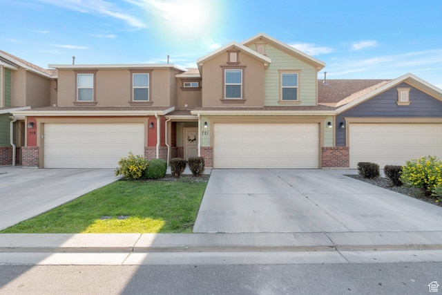 721 S 110 W, Spanish Fork, UT 84660 - view of front of house with brick siding, an attached garage, and driveway
