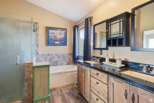 9506 Silver Creek Rd, Park City, UT 84098 - full bath with vaulted ceiling, a shower stall, a garden tub, double vanity, and wood finished floors