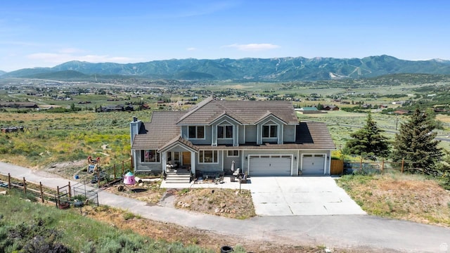 9506 Silver Creek Rd, Park City, UT 84098 - view of front of home featuring driveway, a mountain view, covered porch, an attached garage, and a tile roof