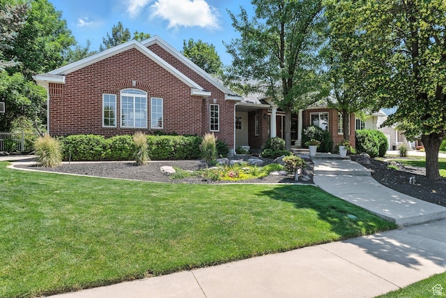 1680 N Camelot Dr E, North Logan, UT 84341 - view of front facade with brick siding and a front lawn