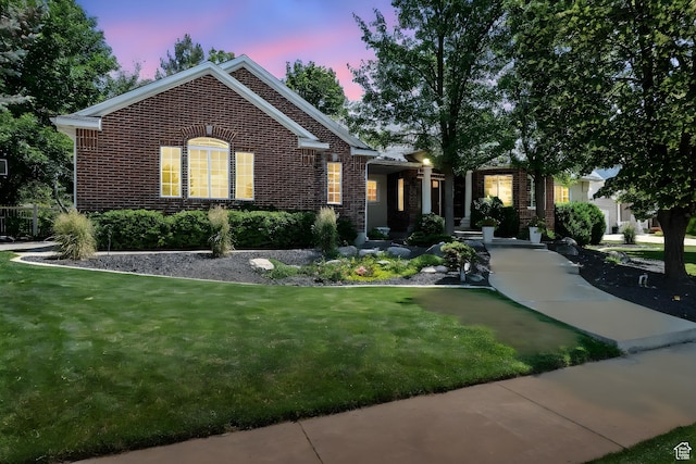 1680 N Camelot Dr E, North Logan, UT 84341 - view of front of property featuring brick siding and a yard
