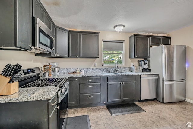 2752 S 9150 W, Magna, UT 84044 - kitchen featuring appliances with stainless steel finishes and light stone countertops