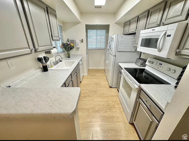 650 S Main St Unit 6111, Bountiful, UT 84010 - kitchen with white appliances, light wood finished floors, light countertops, and gray cabinetry
