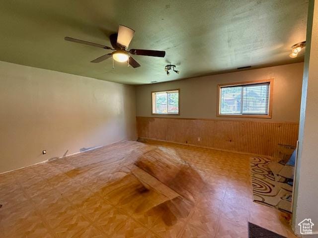 536 N Sundance Cir, Vernal, UT 84078 - empty room with wainscoting, ceiling fan, tile patterned floors, and wood walls