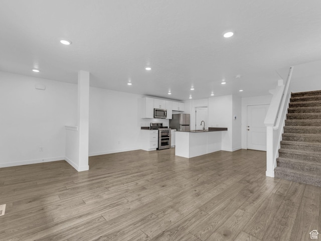 1206 W Summit Ridge Pkwy S Unit 182, Santaquin, UT 84655 - unfurnished living room featuring recessed lighting, stairway, and light wood-style flooring