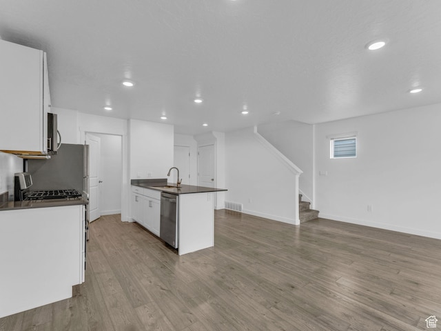 1206 W Summit Ridge Pkwy S Unit 182, Santaquin, UT 84655 - kitchen featuring dark countertops, stainless steel appliances, recessed lighting, white cabinetry, and wood finished floors