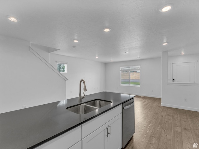 1206 W Summit Ridge Pkwy S Unit 182, Santaquin, UT 84655 - kitchen with stainless steel dishwasher, light wood-type flooring, dark countertops, white cabinetry, and recessed lighting