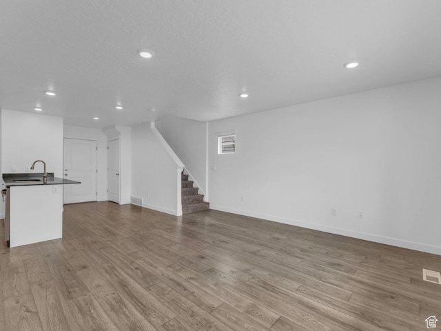 1206 W Summit Ridge Pkwy S Unit 182, Santaquin, UT 84655 - unfurnished living room with recessed lighting, stairway, and wood finished floors