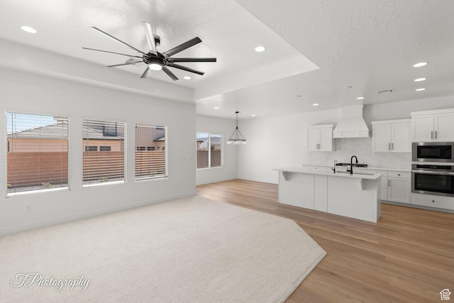 1516 E Mountain Trl, St George, UT 84790 - unfurnished living room with recessed lighting, light wood-style floors, and a ceiling fan