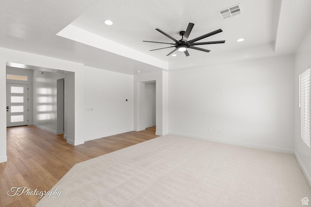 1516 E Mountain Trl, St George, UT 84790 - empty room with ceiling fan, a tray ceiling, recessed lighting, and wood finished floors