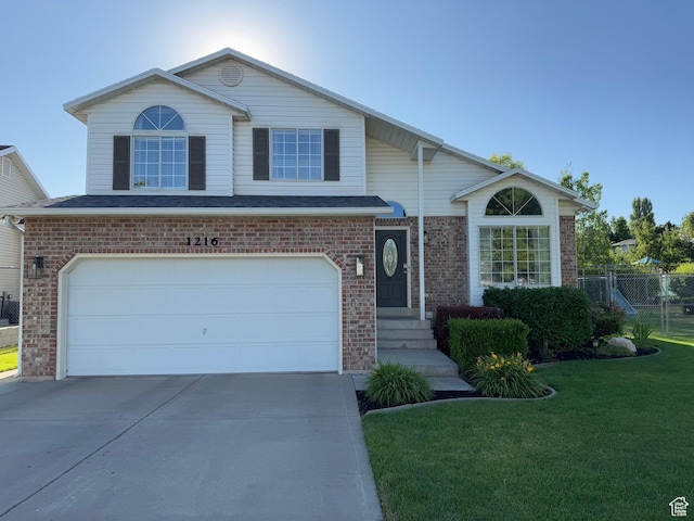 1216 N 2725 W, Layton, UT 84041 - traditional home featuring concrete driveway, brick siding, and a garage