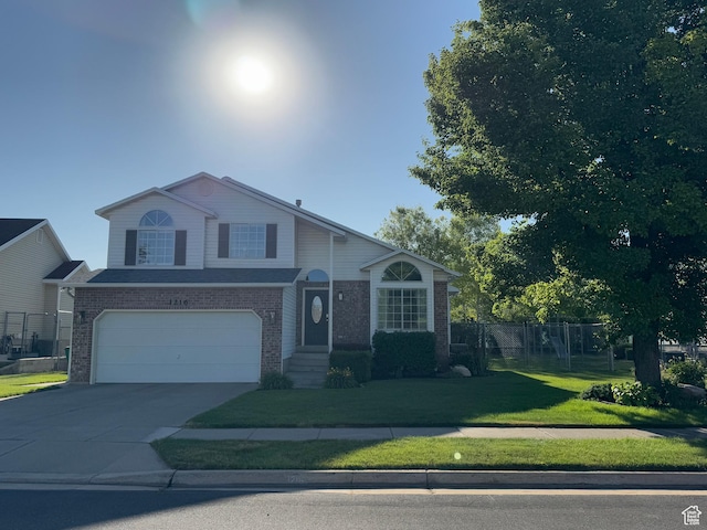 1216 N 2725 W, Layton, UT 84041 - view of front of home with brick siding, an attached garage, and concrete driveway