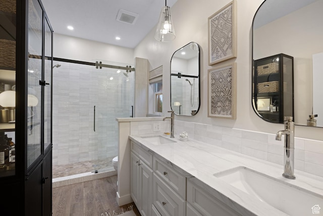 3605 W Wrangler Way, Park City, UT 84098 - bathroom with a shower stall, double vanity, wood finished floors, and recessed lighting