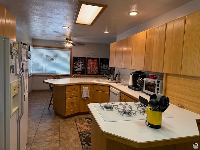 2936 E Ln Joya Dr S, Holladay, UT 84124 - kitchen with a peninsula, white appliances, light countertops, ceiling fan, and recessed lighting