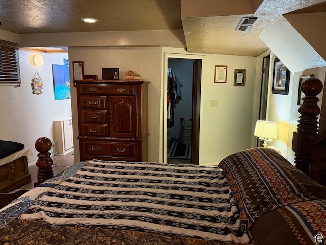 2936 E Ln Joya Dr S, Holladay, UT 84124 - bedroom featuring a textured ceiling and a walk in closet