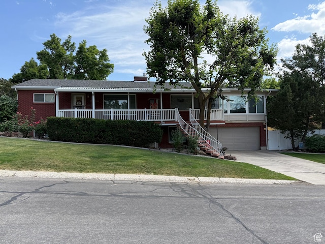 2936 E Ln Joya Dr S, Holladay, UT 84124 - single story home featuring a porch, a front lawn, driveway, and brick siding