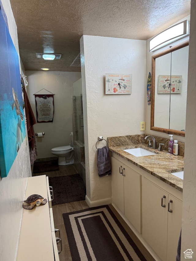 2936 E Ln Joya Dr S, Holladay, UT 84124 - full bath featuring a shower with door, a textured ceiling, double vanity, and wood finished floors