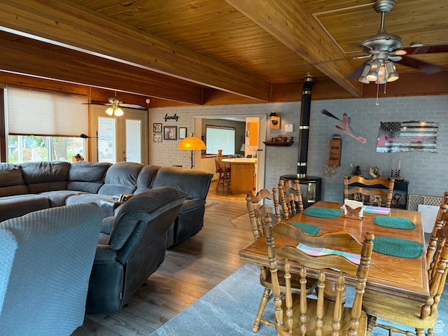 2936 E Ln Joya Dr S, Holladay, UT 84124 - dining area featuring a ceiling fan, brick wall, a wood stove, wood finished floors, and a wood ceiling with exposed beams