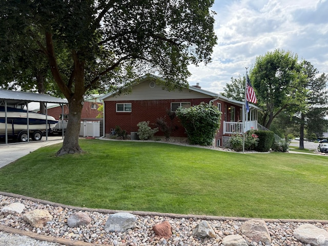 2936 E Ln Joya Dr S, Holladay, UT 84124 - view of side of home featuring brick siding, a yard, and a carport