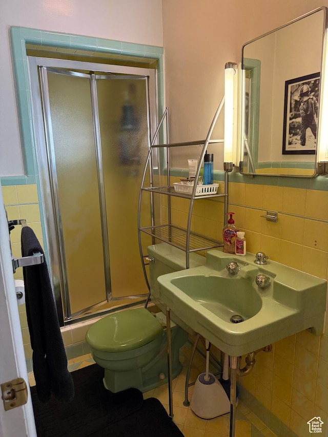 2936 E Ln Joya Dr S, Holladay, UT 84124 - full bath with tile walls, a stall shower, tile patterned flooring, and wainscoting