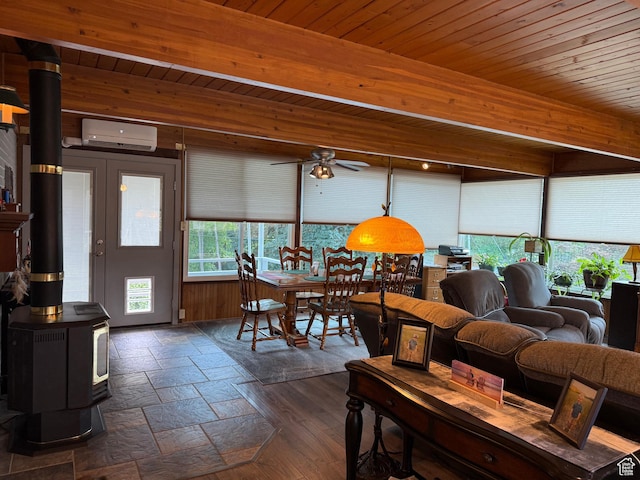 2936 E Ln Joya Dr S, Holladay, UT 84124 - living area with a wall unit AC, a wood stove, wood ceiling, ceiling fan, and stone tile flooring