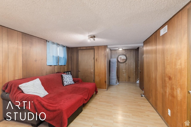 4370 S 175 E, Washington Terrace, UT 84405 - living room with light wood finished floors, wood walls, and a textured ceiling