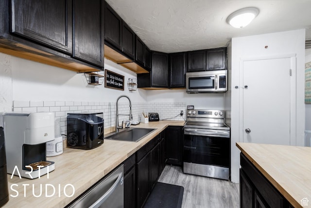 4370 S 175 E, Washington Terrace, UT 84405 - kitchen featuring appliances with stainless steel finishes, wood counters, light wood-style floors, and dark cabinets