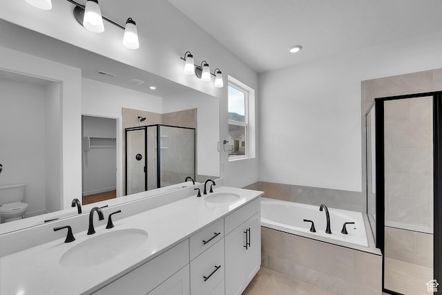 3197 E 1000 S Unit 201, Spanish Fork, UT 84660 - full bath featuring a stall shower, double vanity, a bath, a walk in closet, and tile patterned flooring