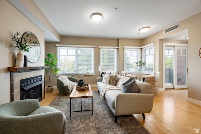 1988 S 1100 E Unit 308, Salt Lake City, UT 84105 - living area with hardwood / wood-style flooring and a tiled fireplace
