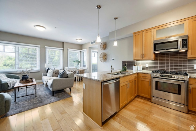 1988 S 1100 E Unit 308, Salt Lake City, UT 84105 - kitchen featuring appliances with stainless steel finishes, open floor plan, and light wood-style floors