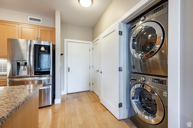 1988 S 1100 E Unit 308, Salt Lake City, UT 84105 - laundry room with estacked washer and dryer and light wood-style floors
