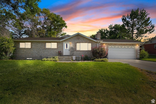 117 E 300 S, Gunnison, UT 84634 - ranch-style house with brick siding, concrete driveway, a chimney, an attached garage, and a front yard