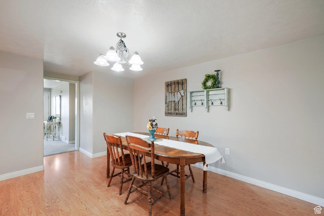 117 E 300 S, Gunnison, UT 84634 - dining area featuring light wood finished floors and a chandelier
