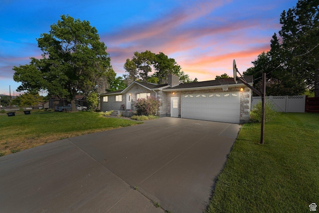 117 E 300 S, Gunnison, UT 84634 - ranch-style house featuring an attached garage, concrete driveway, a chimney, and stone siding