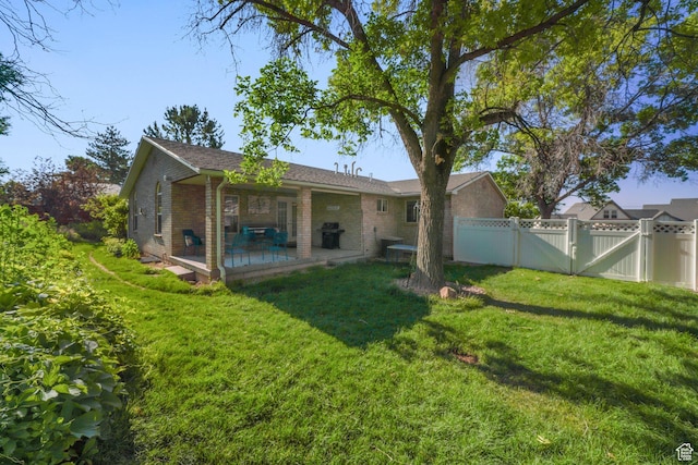 117 E 300 S, Gunnison, UT 84634 - back of house with brick siding, a gate, and a patio