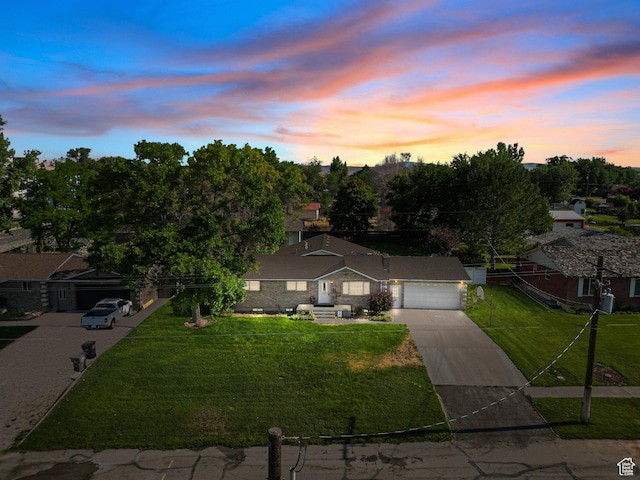 117 E 300 S, Gunnison, UT 84634 - view of front of house featuring concrete driveway, a lawn, and an attached garage