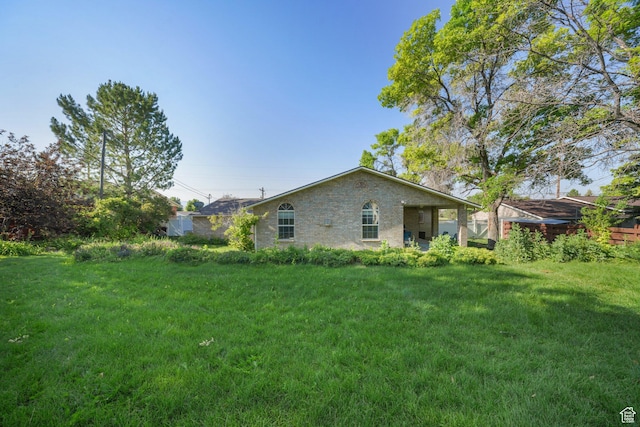 117 E 300 S, Gunnison, UT 84634 - rear view of house with a lawn and brick siding