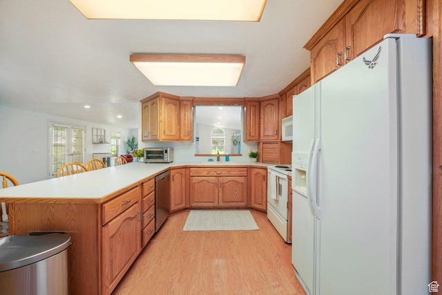 117 E 300 S, Gunnison, UT 84634 - kitchen with white appliances, light countertops, light wood-style flooring, a peninsula, and recessed lighting