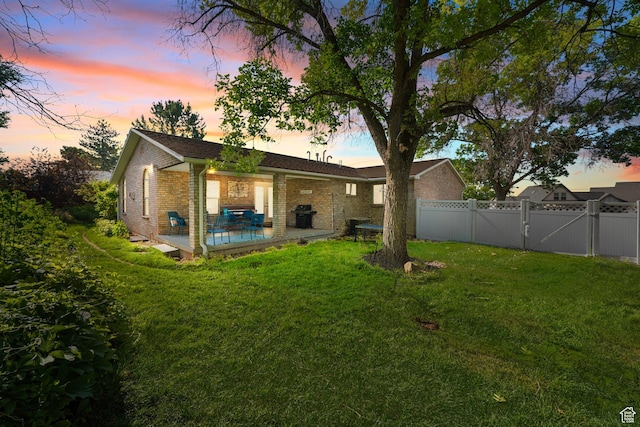 117 E 300 S, Gunnison, UT 84634 - rear view of house with brick siding, a patio area, and a gate