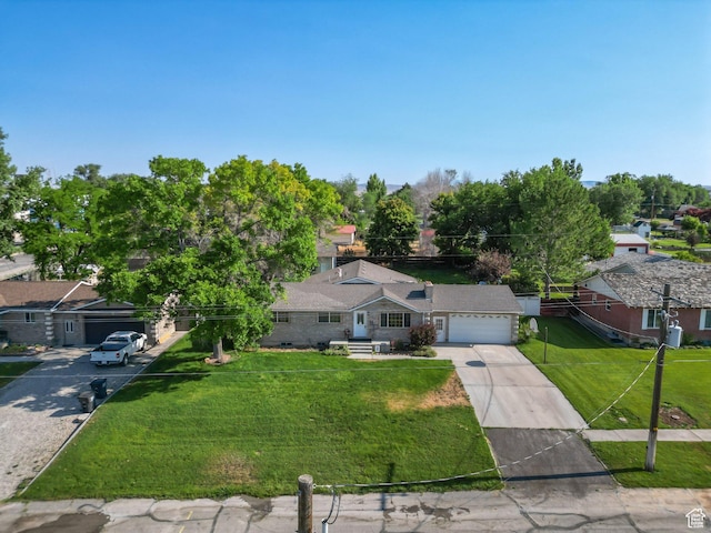 117 E 300 S, Gunnison, UT 84634 - view of front facade featuring concrete driveway, an attached garage, a front yard, and a residential view