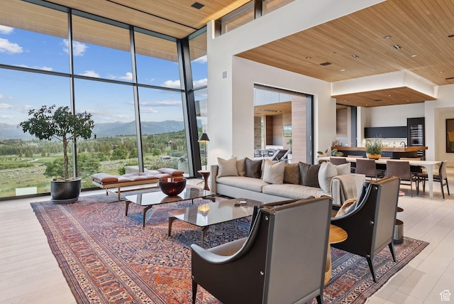 8078 N Red Fox Ct, Park City, UT 84098 - living area with expansive windows, a mountain view, wooden ceiling, and wood finished floors