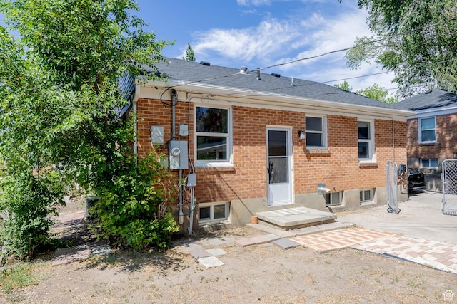 1639 20th S, Ogden, UT 84401 - rear view of house with brick siding, roof with shingles, and a patio