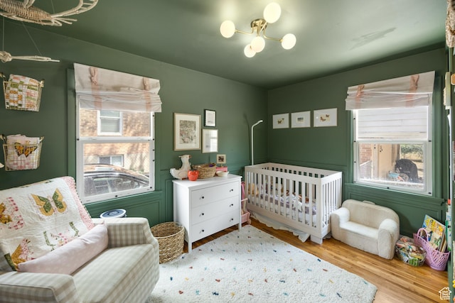 1639 20th S, Ogden, UT 84401 - bedroom with a chandelier, wood finished floors, and a nursery area