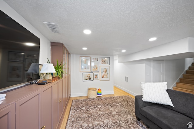1639 20th S, Ogden, UT 84401 - living area with light wood-style flooring, a textured ceiling, stairs, and recessed lighting