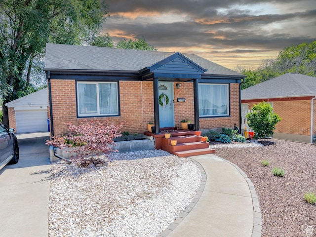 1639 20th S, Ogden, UT 84401 - view of front of home featuring brick siding, a garage, a shingled roof, and an outbuilding